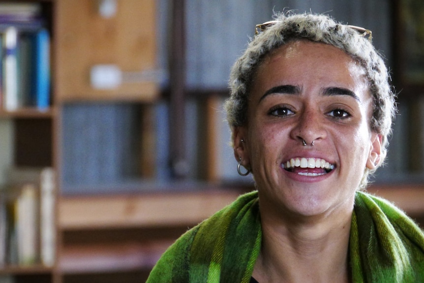 Close up photo of a woman smiling and looking at the camera 