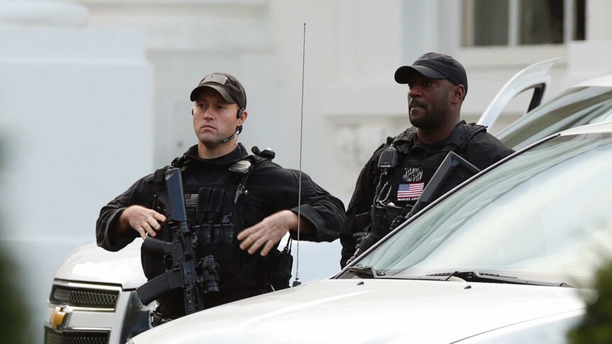 Secret Service members patrol the White House after Dominic Adesanya was charged over the security scare on October 23, 2014.