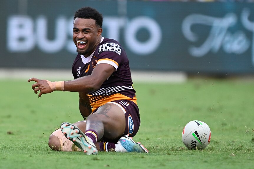 Brisbane Broncos' Ezra Mam slides on his knee after a try in the NRL match against North Queensland Cowboys.
