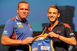 Brisbane coach Justin Leppitsch presents James Aish with a Lions guernsey at the AFL Draft.