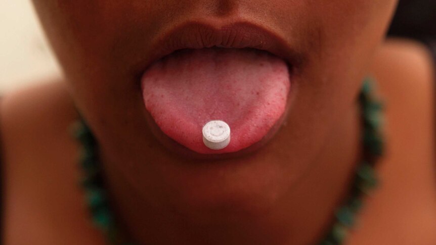 Girl with ecstasy tablet