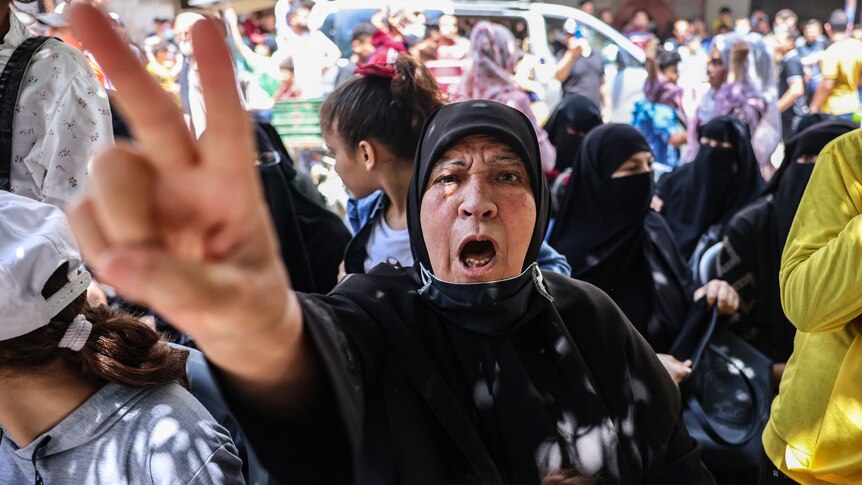 A Palestinian woman celebrates ceasefire in Gaza