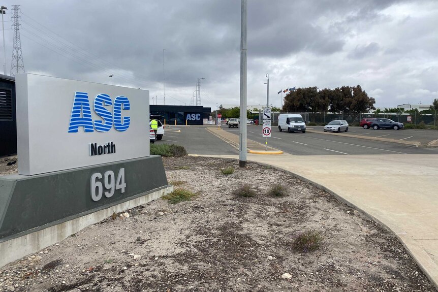 A sign with the words ASC North in front of a car park