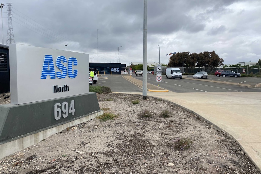 A sign with the words ASC North in front of a car park