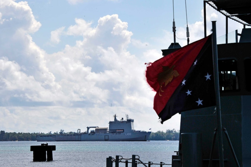 A ship sits in the water on Manus Island.