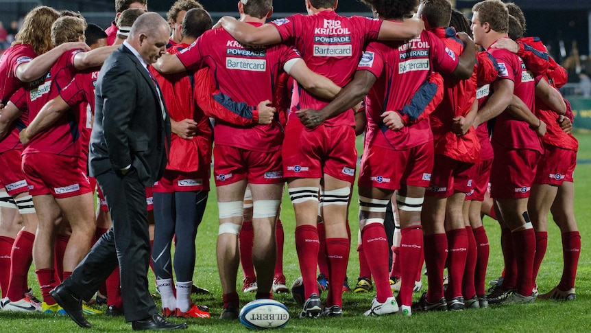 Reds coach Ewen McKenzie with his players in his final game as coach against the Crusaders.