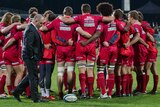 Reds coach Ewen McKenzie with his players in his final game as coach against the Crusaders.