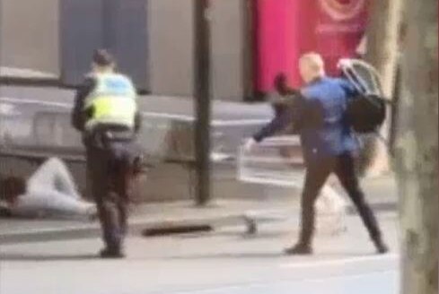 A man holds a chair during the Bourke Street attack