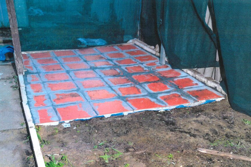 A section of freshly laid orange paving in the backyard of Jemma Lilley's house, next to an area of dirt.