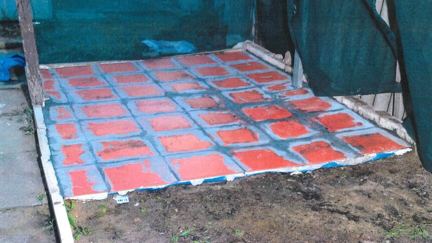A section of freshly laid orange paving in the backyard of Jemma Lilley's house, next to an area of dirt.