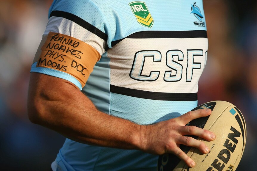 The Sharks' Paul Gallen wears an arm band featuring names of sacked and stood down Cronulla staff.