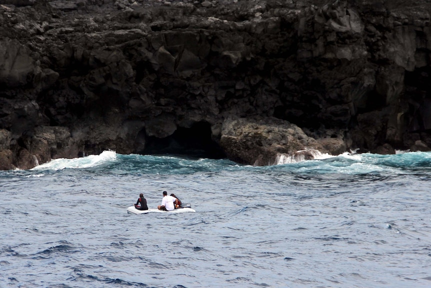 The SY Patriot crew searches for debris from the wrecked yacht Navillus.