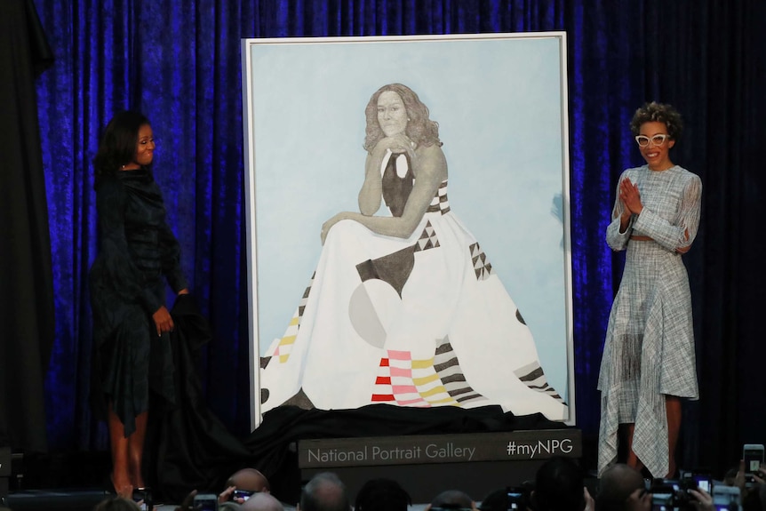 Former first lady Michelle Obama beside her official portrait