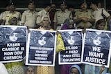 Victims of the Bhopal gas tragedy hold posters during a demonstration outside a court