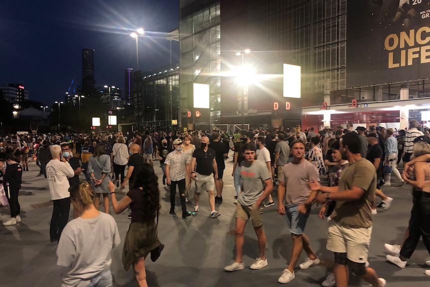 A large crowd is pictured at night at Lang Park.