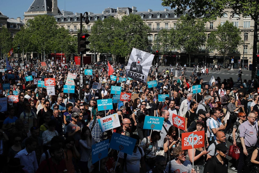 Anti-President Macron protesters march in downtown Paris, France, Saturday, May 5, 2018.