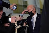 President Joe Biden talks with reporters at the White House.
