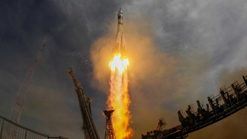A wide view shows the Soyuz MS-04 spacecraft blasting off.