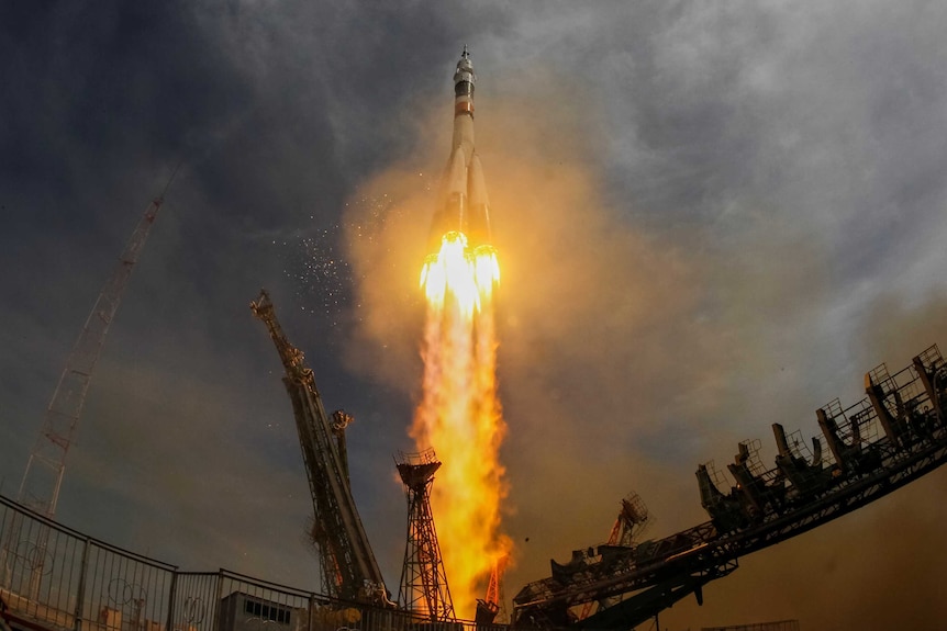 A wide view shows the Soyuz MS-04 spacecraft blasting off.
