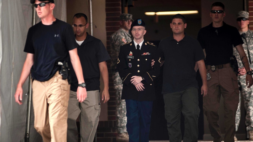 Bradley Manning is escorted out of court after closing arguments.