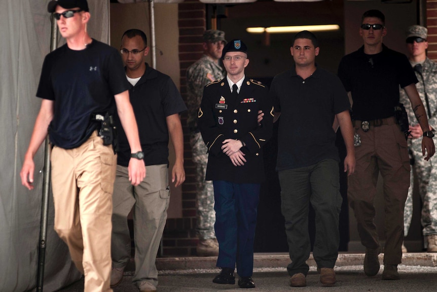 Bradley Manning is escorted out of court after closing arguments.
