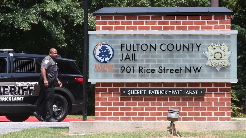 A sign reading "Fulton County jail" and a sign reading "Sheriff Patrick 'Pat' Labat" underneath it
