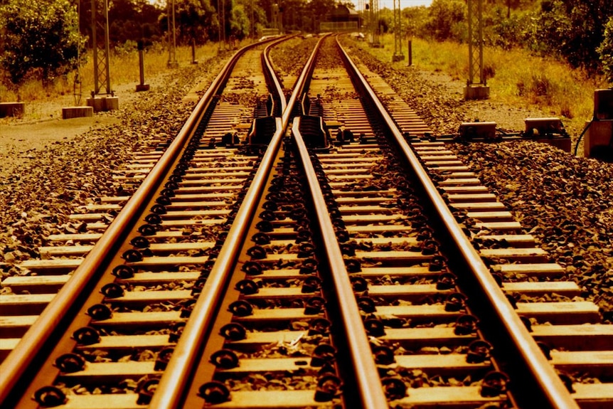 Close up of train tracks which go off in the distance.