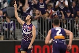 The Dockers' Alex Pearce points to the sky after kicking a late goal against the Magpies.