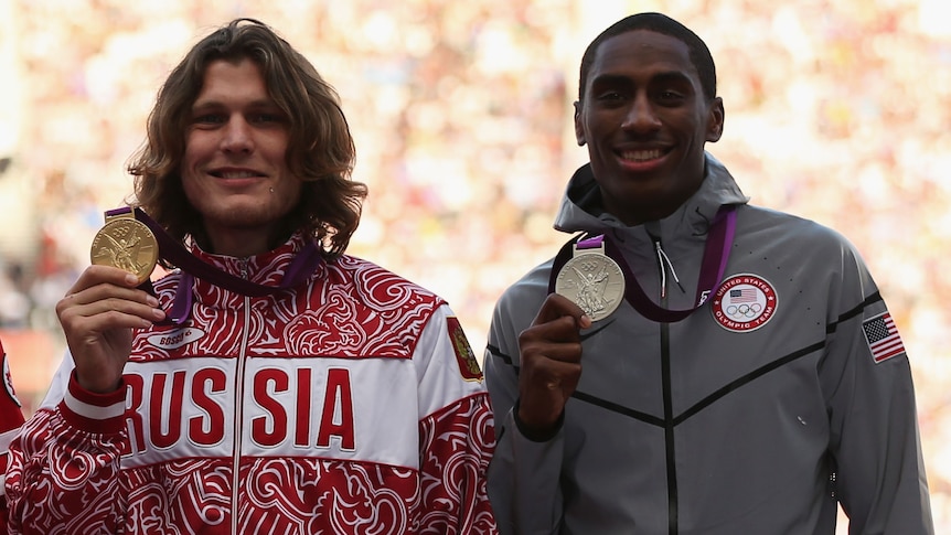 Five male high jumpers stand on a podium holding their medals at the 2012 London Olympics