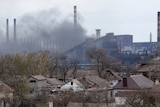Smoke rises from an industrial plant.