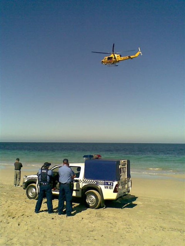 Blood in the water: Police at the scene of the shark attack.