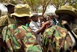 Kenyan security forces talk with residents at a village near Kenya's border town with Somalia on October 15, 2011.