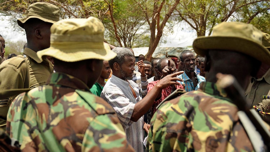 Venturing deep: Kenyan security forces with residents near the border with Somalia.
