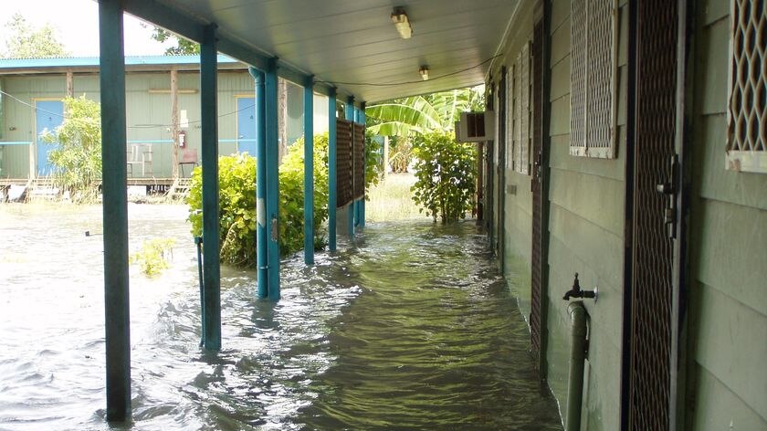 Water laps at the walls of a building during a king tide on Saibai Island.