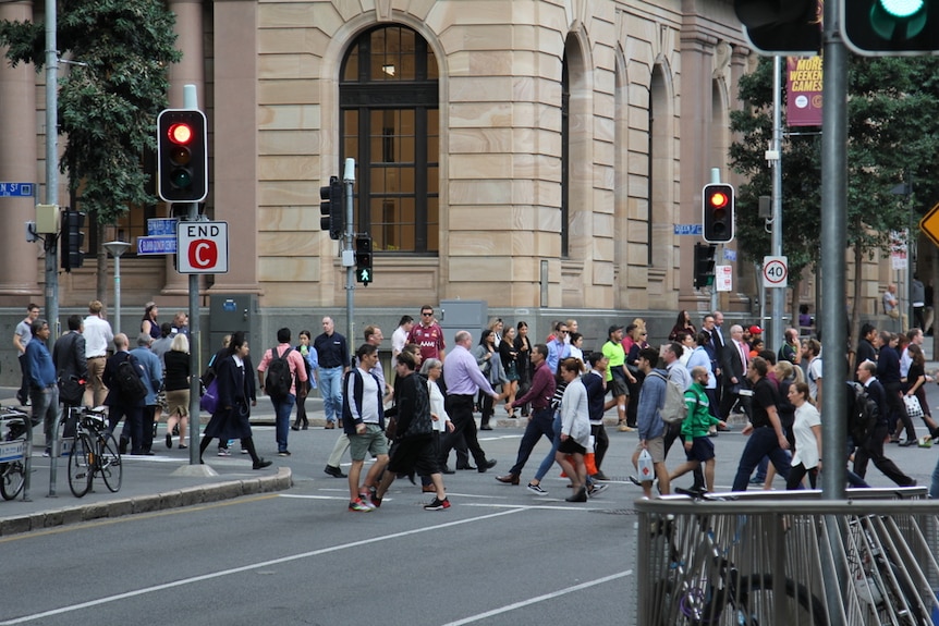 People cross at an intersection in Brisbane CBD in June 2018.