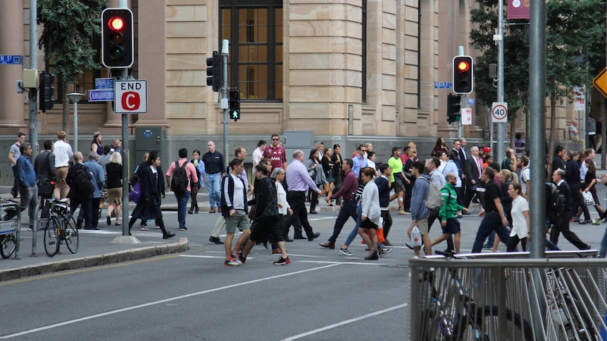 People cross at an intersection in Brisbane CBD in June 2018.