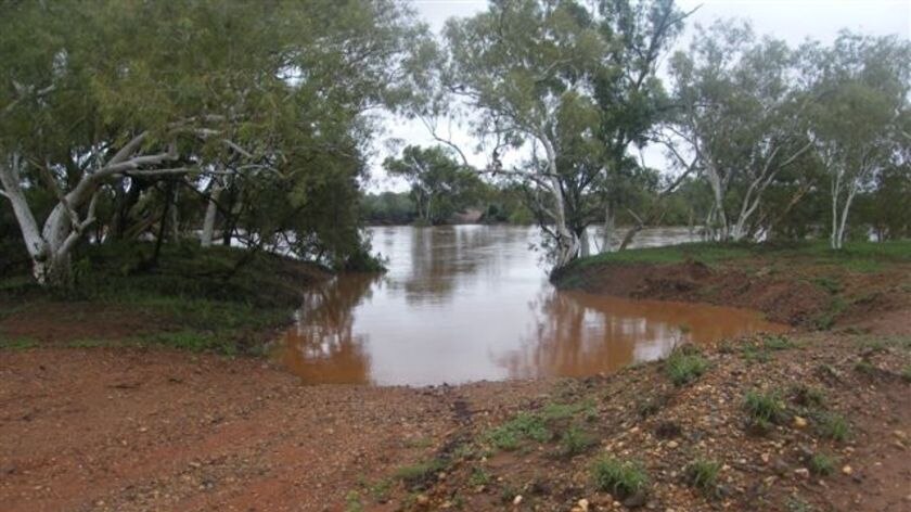 A road crossing at Warrawagine Station, east of Marble Bar, washed out by the rising Nullagine River