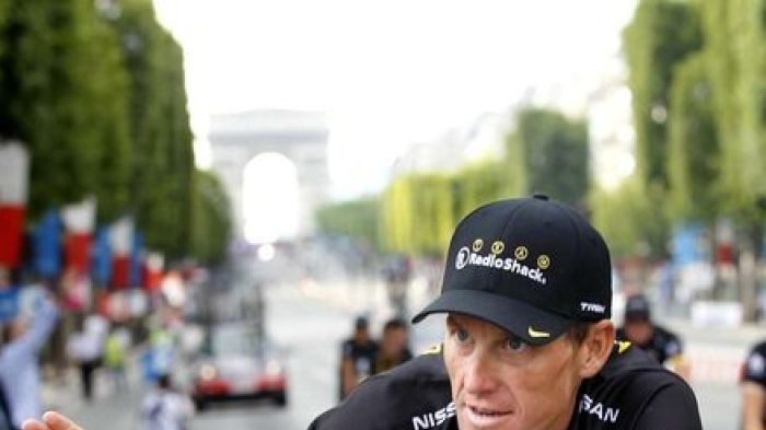 Saying goodbye: Armstrong farewells the 2010 Tour on the Champs Elysees.