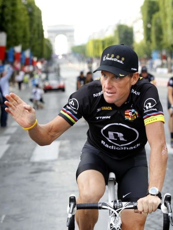 Saying goodbye: Armstrong farewells the 2010 Tour on the Champs Elysees.