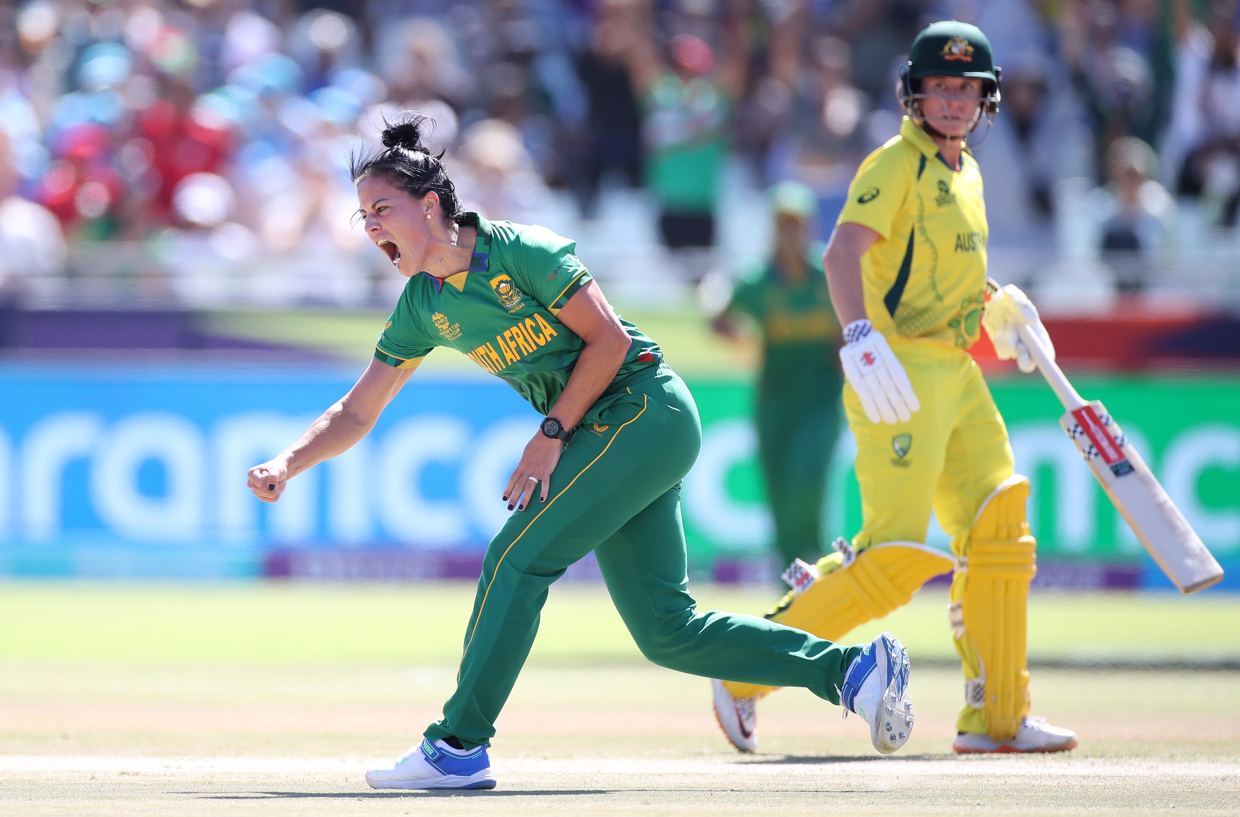 Marizanne Kapp pumps her fist and screams after taking a wicket, Beth Mooney watches on from behind