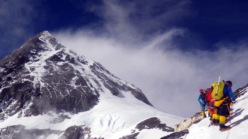 Mount Everest with climbers in the foreground