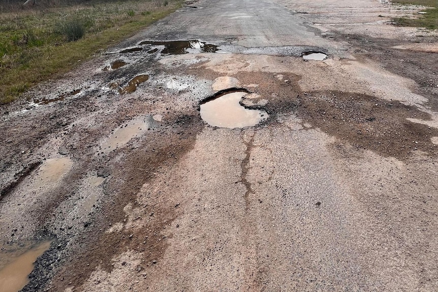 holes in the road filled with water from rain