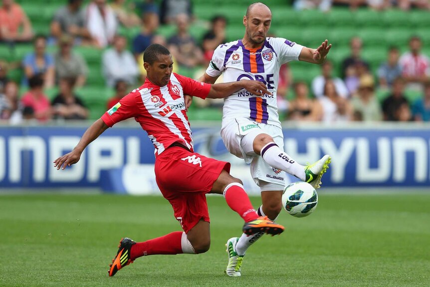 Melbourne Heart's Patrick Gerhardt challenges Perth's Billy Mehmet for the ball.