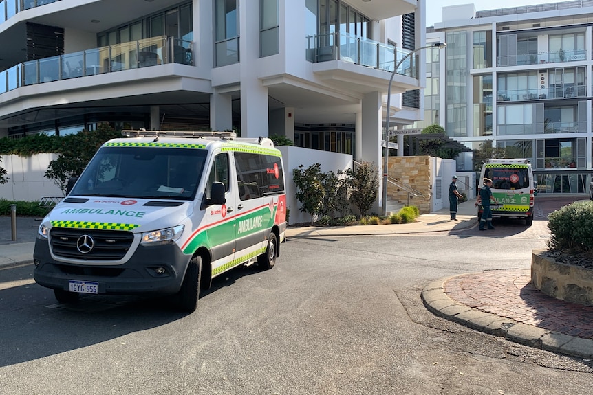 Two ambulances on a street. 