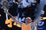 Rafael Nadal raises his arms in triumph after beating Tomas Berdych at Melbourne Park.