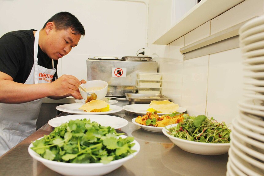 Nabin Gurung preparing dishes in Launceston
