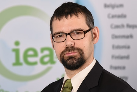 A close up shot of IEA chief economist Laszlo Varro wearing glasses and a suit