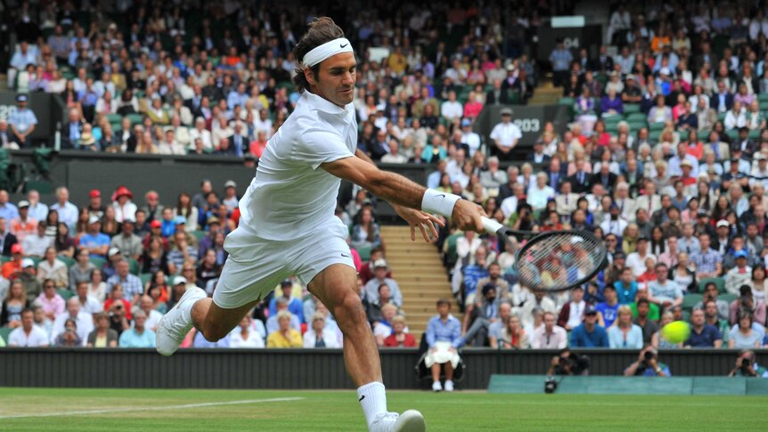 Roger Federer hits a forehand against Gilles Muller