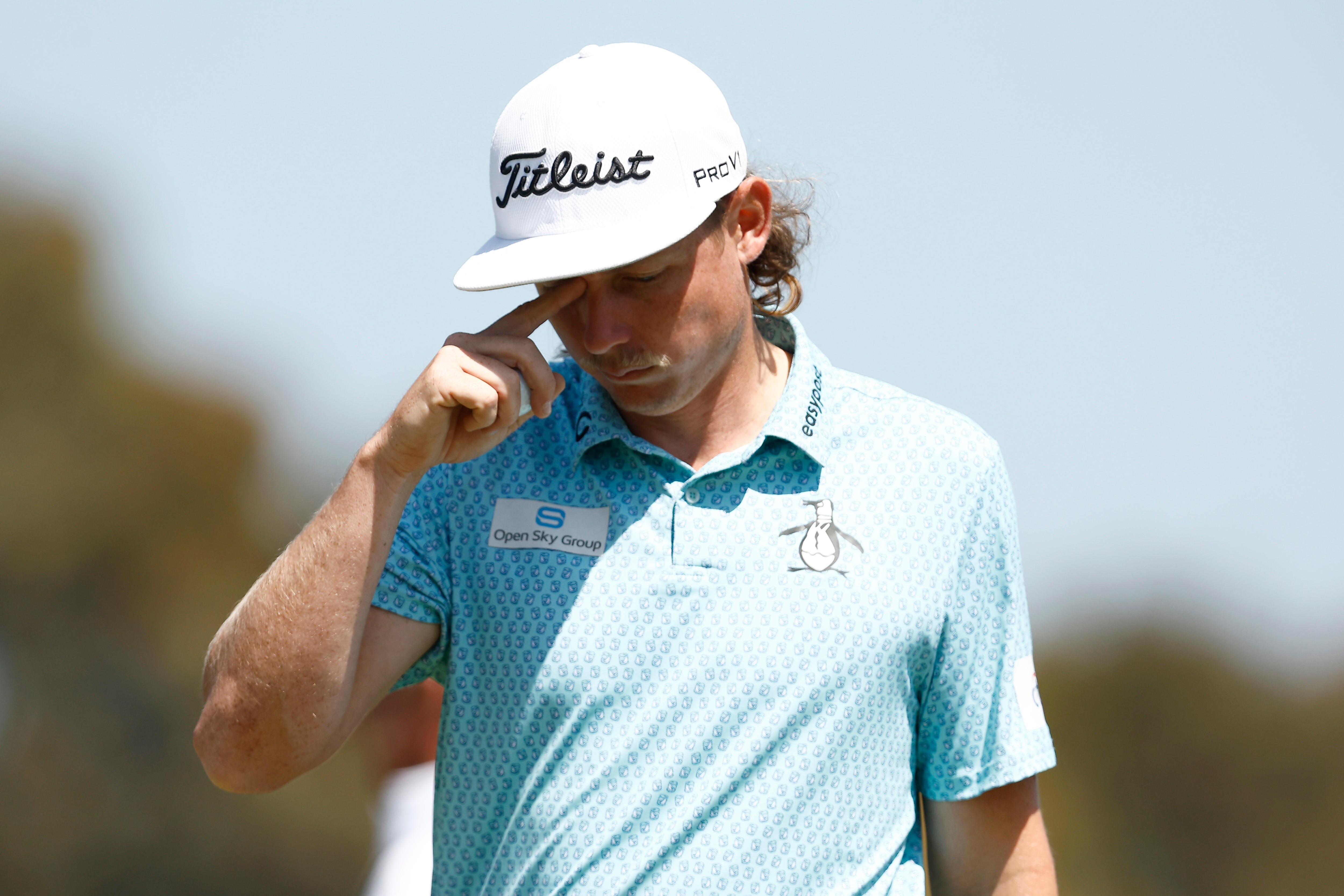 Cameron Smith rubs his right eye with one of his fingers at the Australian Open.