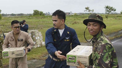 Sailors from the USS Abraham Lincoln load a truck with supplies to be distributed in Indonesia